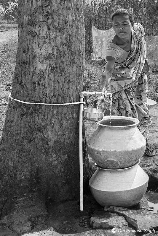 Fetching water from a ‘makeshift’ FHTC outside the house in a village under Jal Jeevan Mission in Seraikela-Kharsawan district, Jharkhand, India